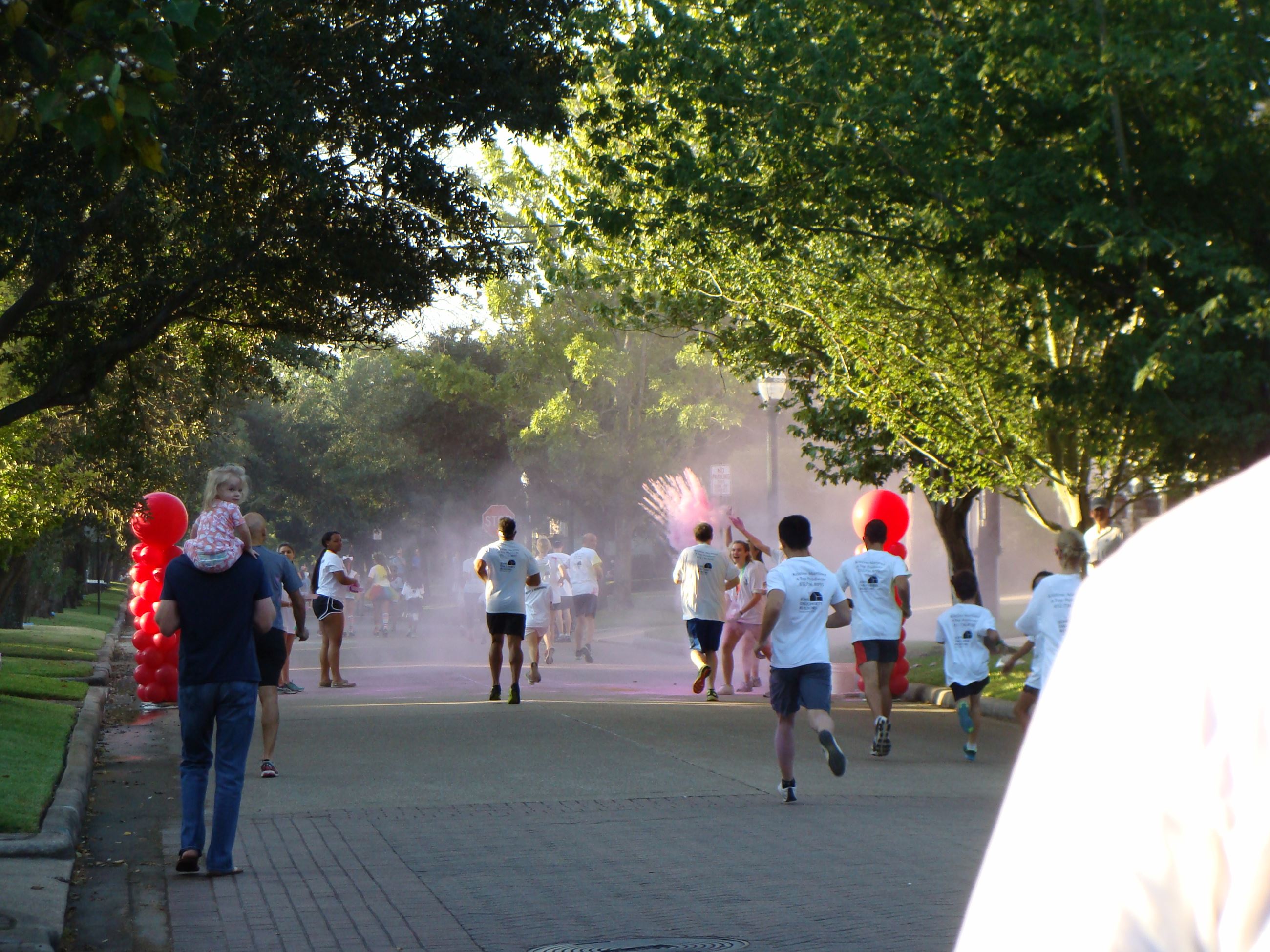 Runners approaching a cloud of colored powder